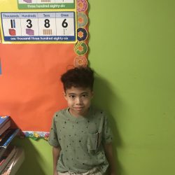 A student smiling for the camera at West Hills Preschool & Afterschool in West Hills, California